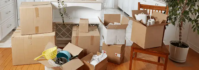 Packed moving boxes and household items in a kitchen before move-out or move-in cleaning, New Orleans, LA.